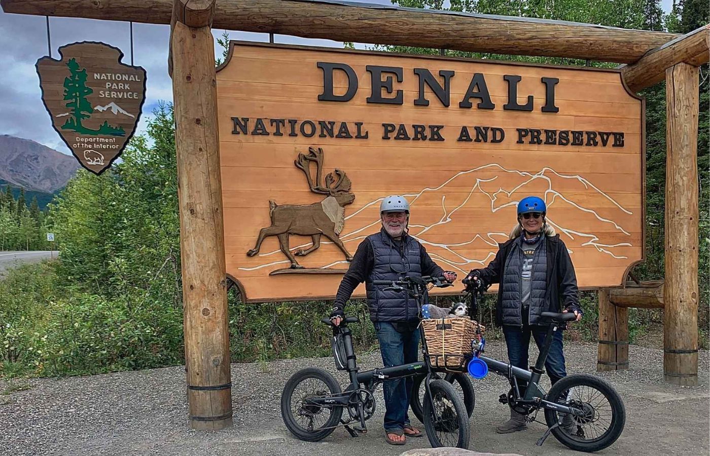 Elderly couple traveling The denall national park with pets on qualisports dolphin folding e-bikes