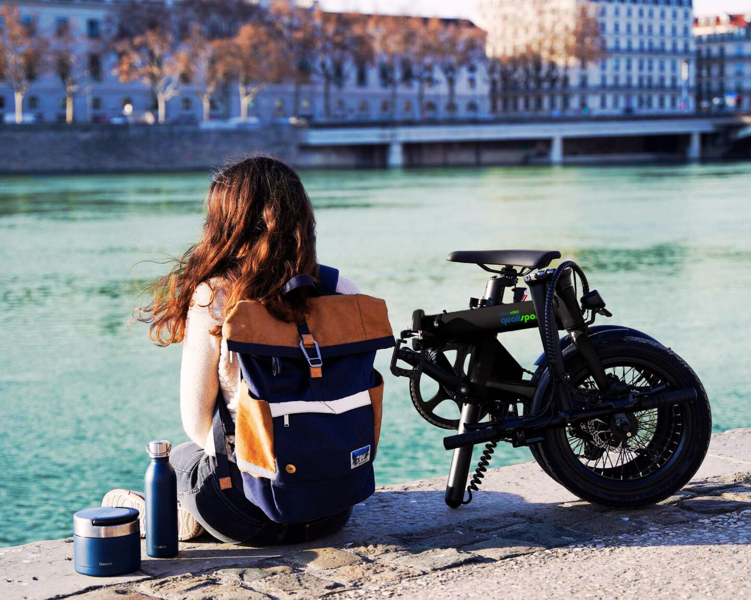 The girl sitting next to the black Volador ebike